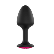 Black anal plug with a red gem base.