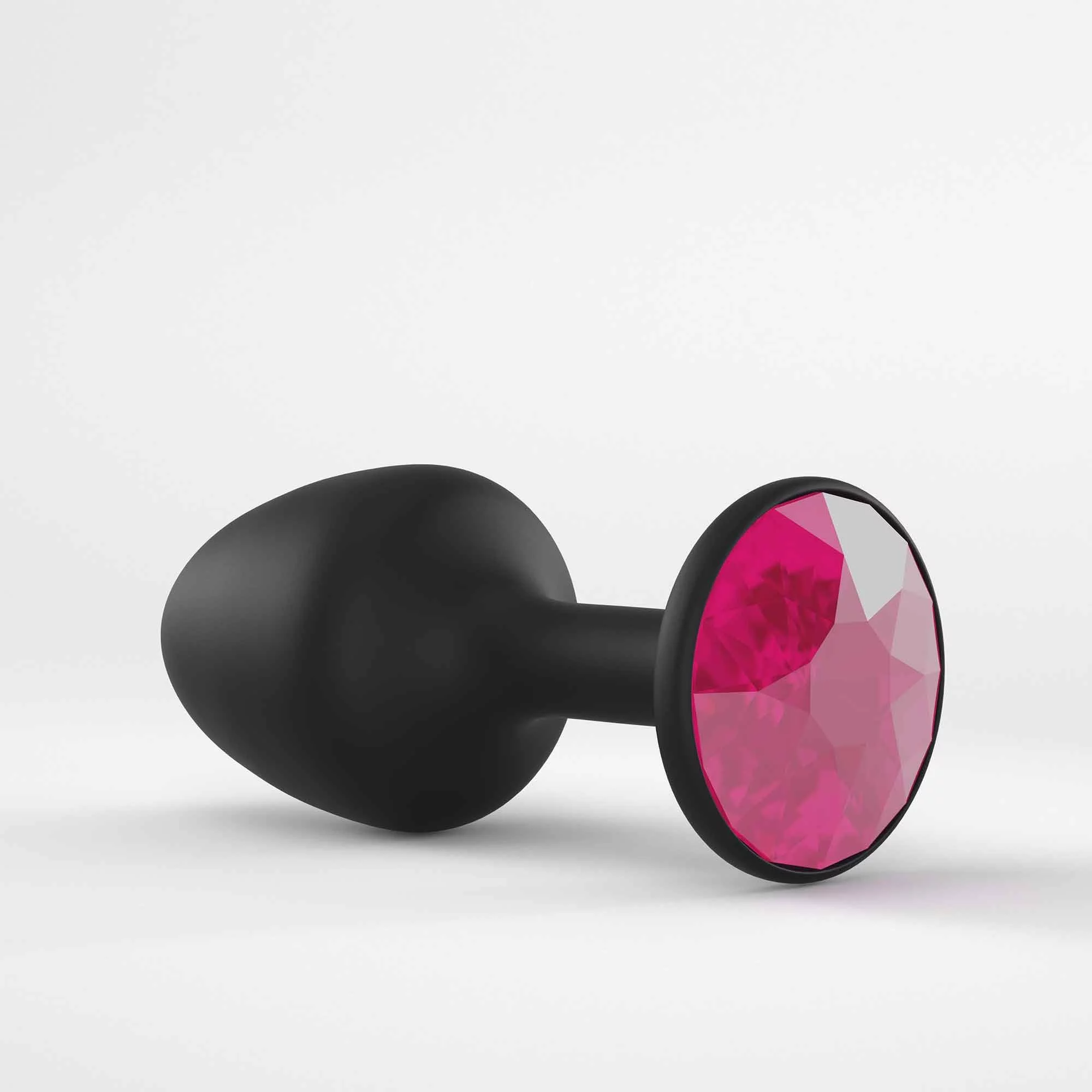Black anal plug with a faceted ruby-colored gem.