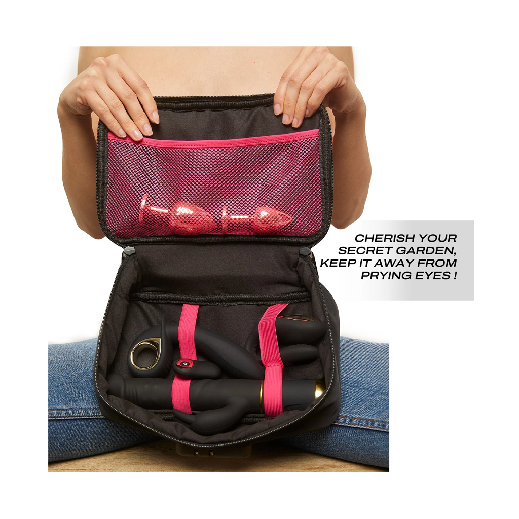 Black discreet storage box with pink mesh pocket and elastic straps holding adult toys.