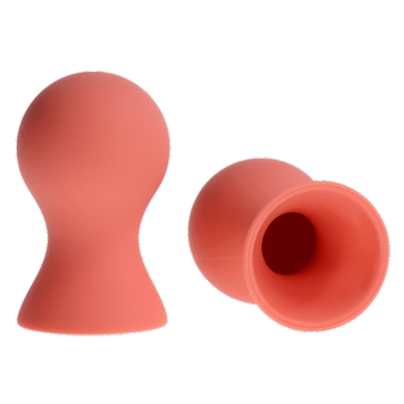 Two coral-colored silicone nipple suckers on a white background.
