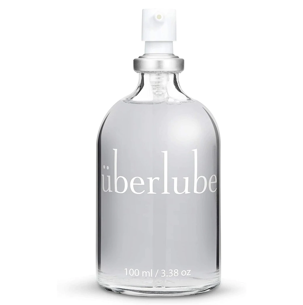 Überlube silicone personal lubricant in a clear glass bottle with a white pump dispenser.