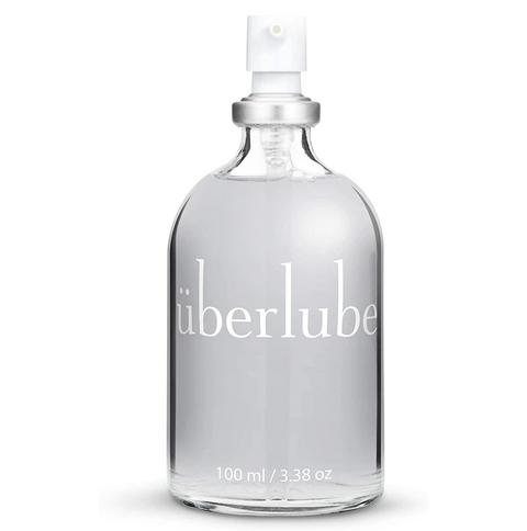 Überlube silicone personal lubricant in a clear glass bottle with a white pump dispenser.
