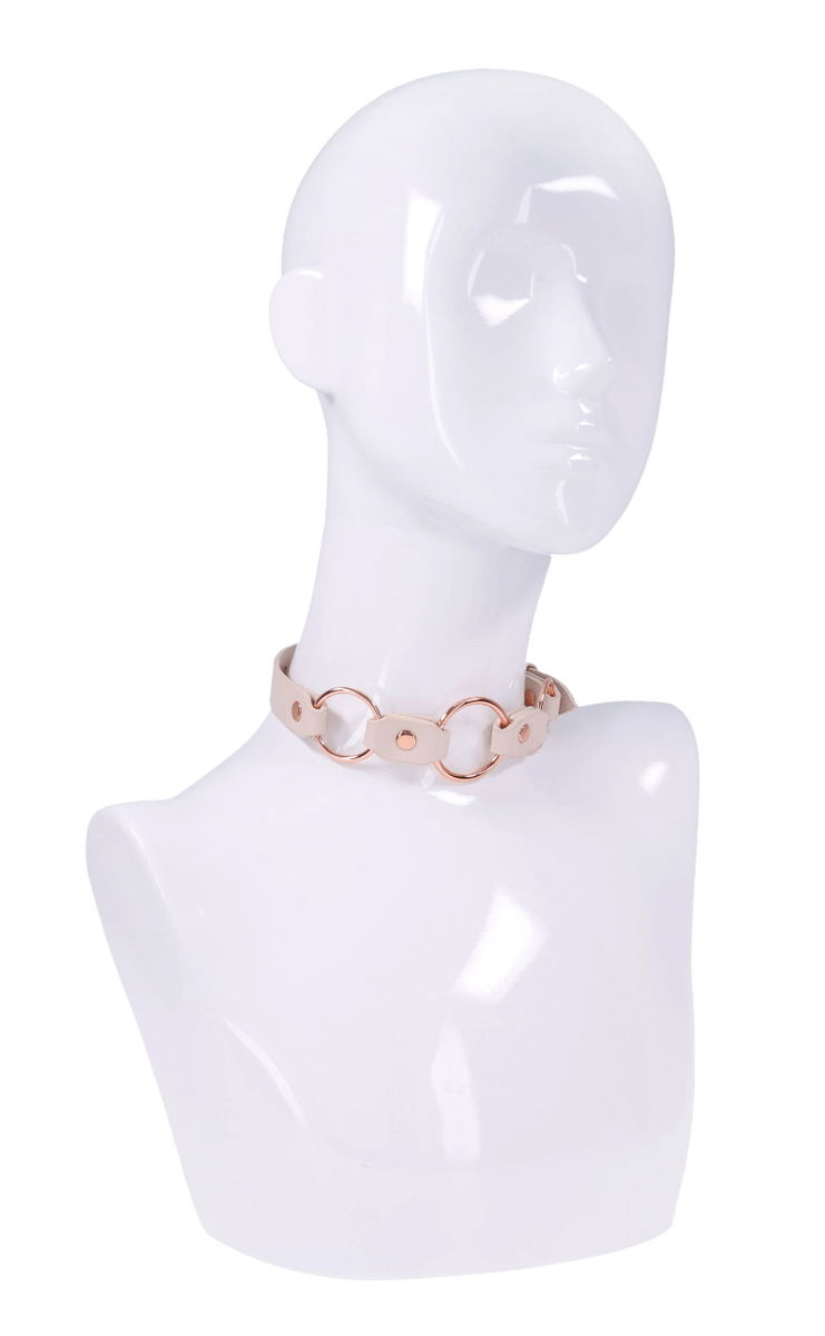 Faux leather day collar with rose gold rings on a mannequin bust.