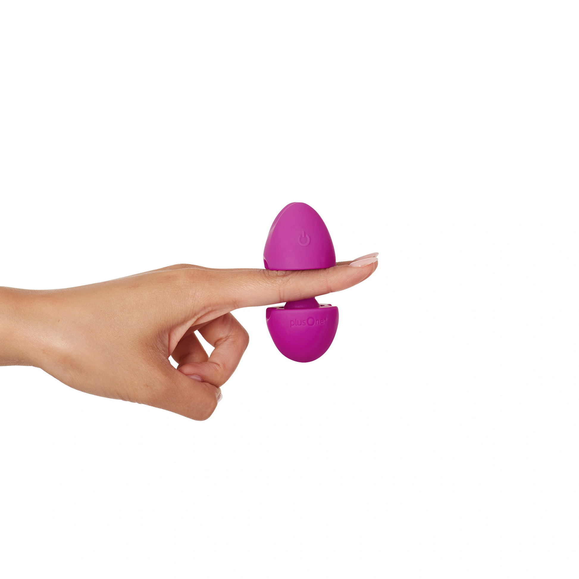 A purple plusOne pop-up vibrator rests on a finger.