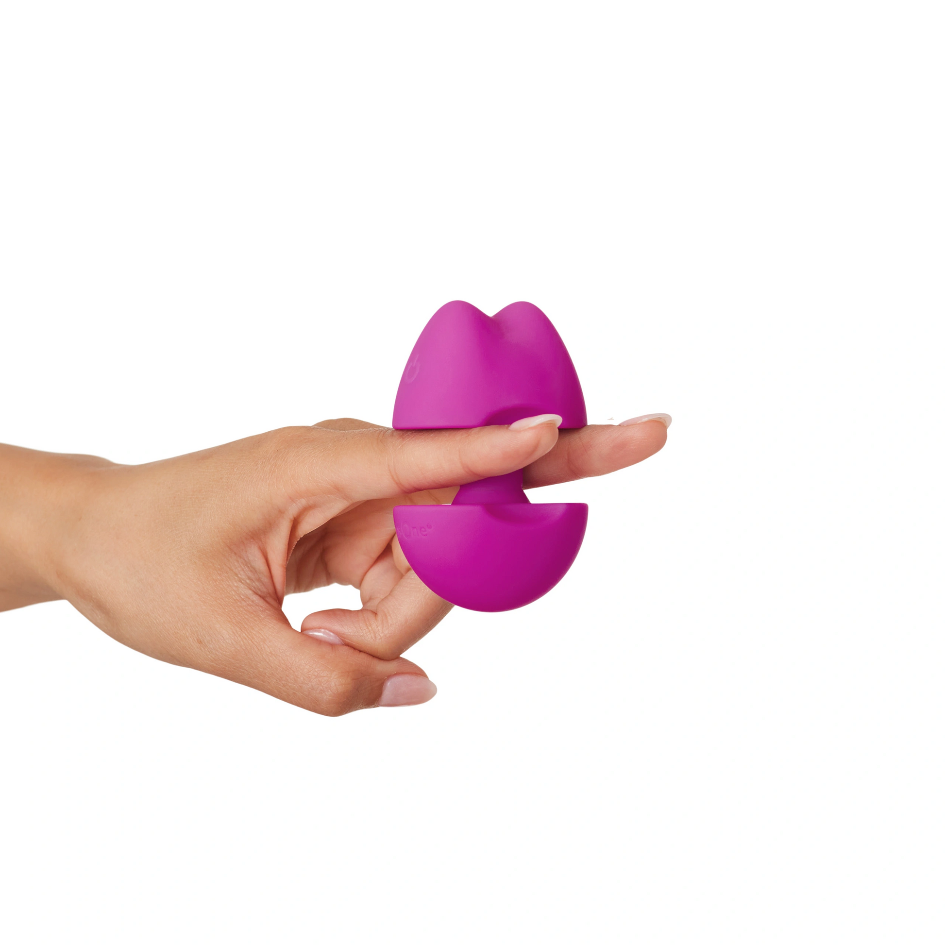A purple vibrator shaped like lips is held on a finger.