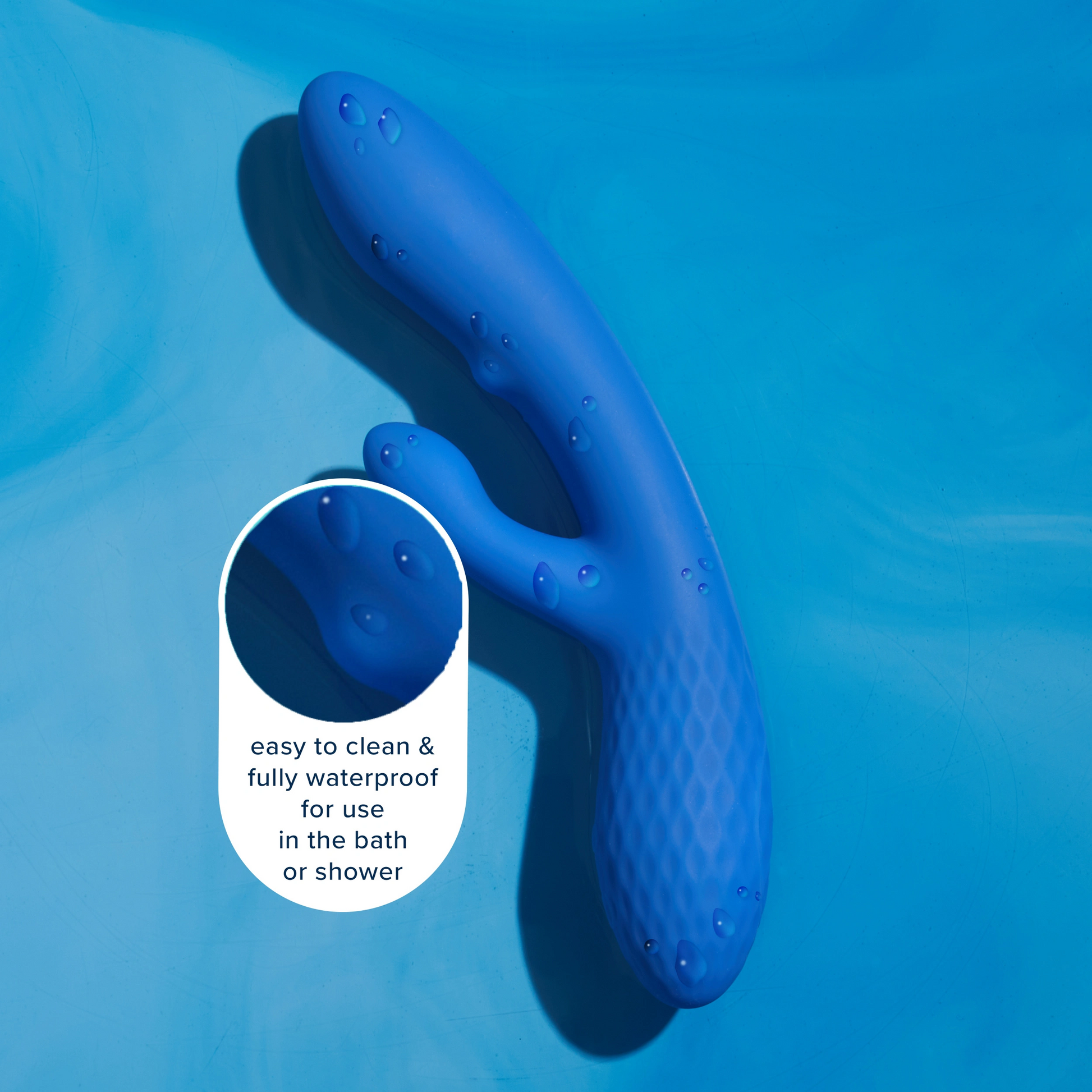 A blue dual g-spot massager with water droplets on it.