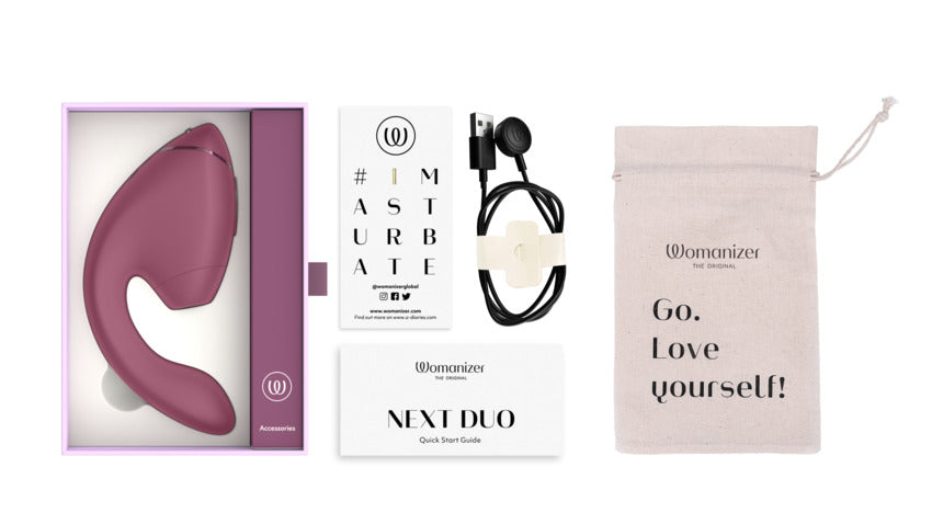 Womanizer Next Duo dual stimulator in dusky pink with accessories.