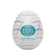 A white egg-shaped Tenga masturbator with wavy silver lines and a teal label.
