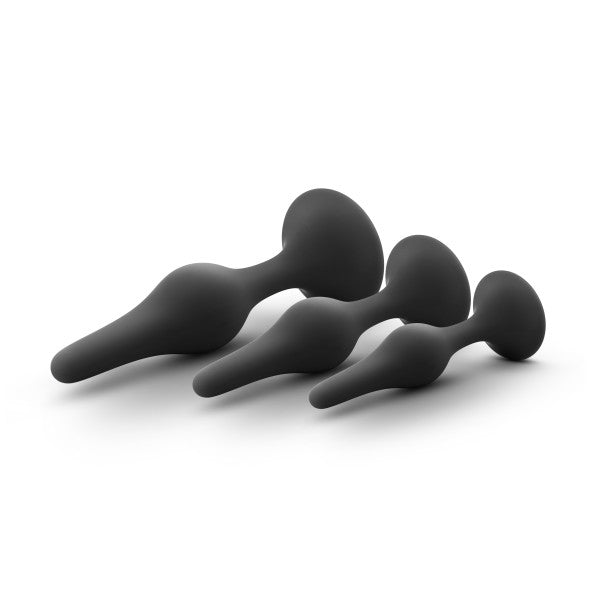 Three black silicone anal plugs of graduated sizes.