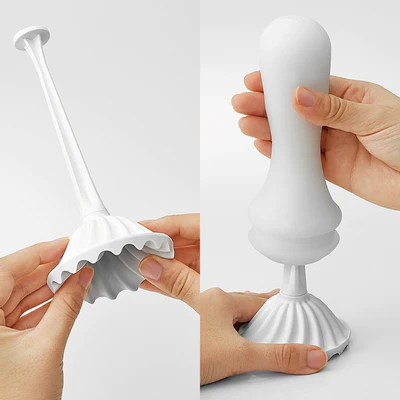 White reusable stroker with a ribbed texture and a long handle.