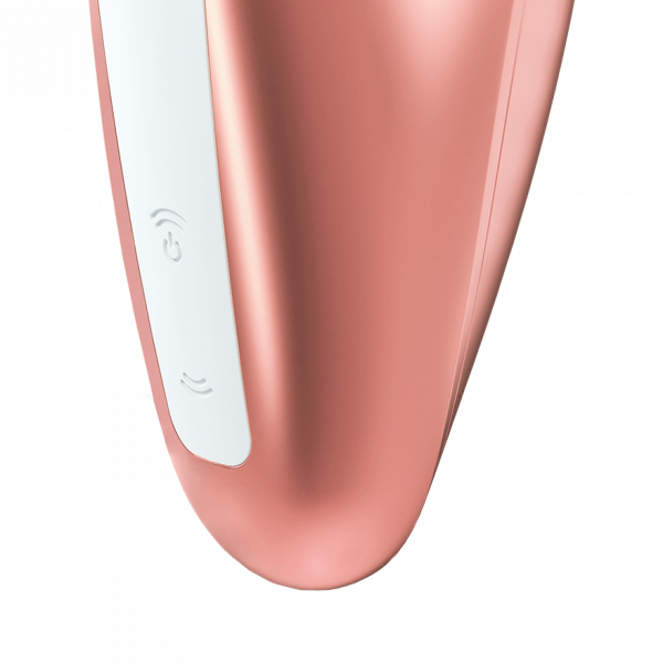 Close-up of a rose gold clitoral stimulator with white buttons.