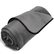 Rolled grey microvelvet blanket with black trim.