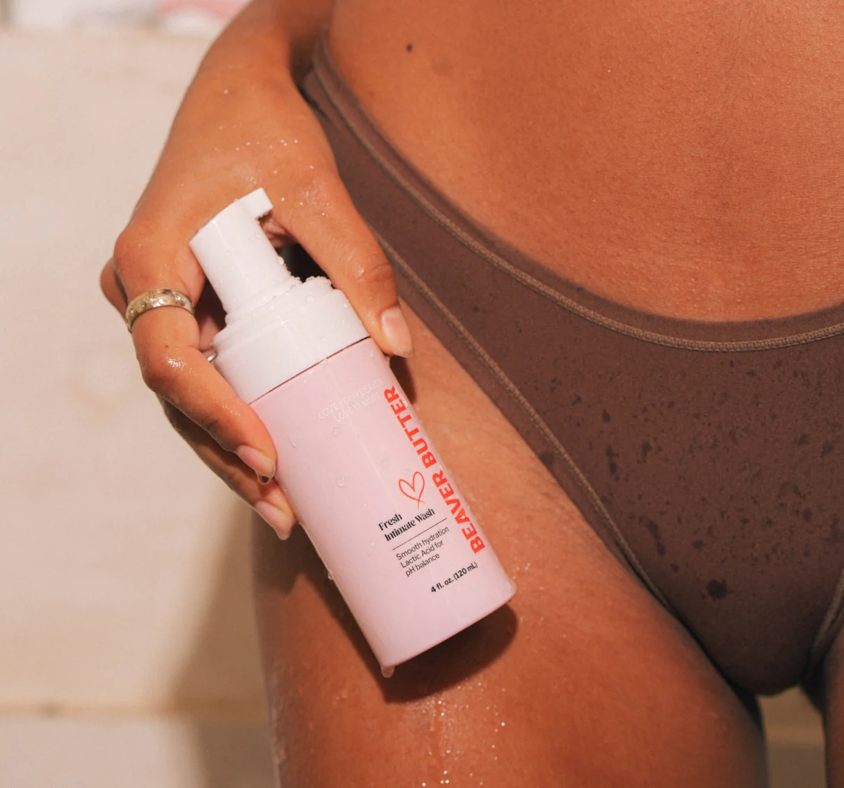 A pink bottle of Beaver Butter Fresh Intimate Wash with a pump dispenser.