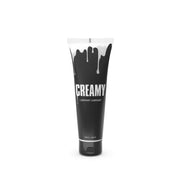 A black tube of "Creamy" lubricant with white dripping paint design.