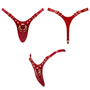 Red leatherette strap-on harness with gold rings.