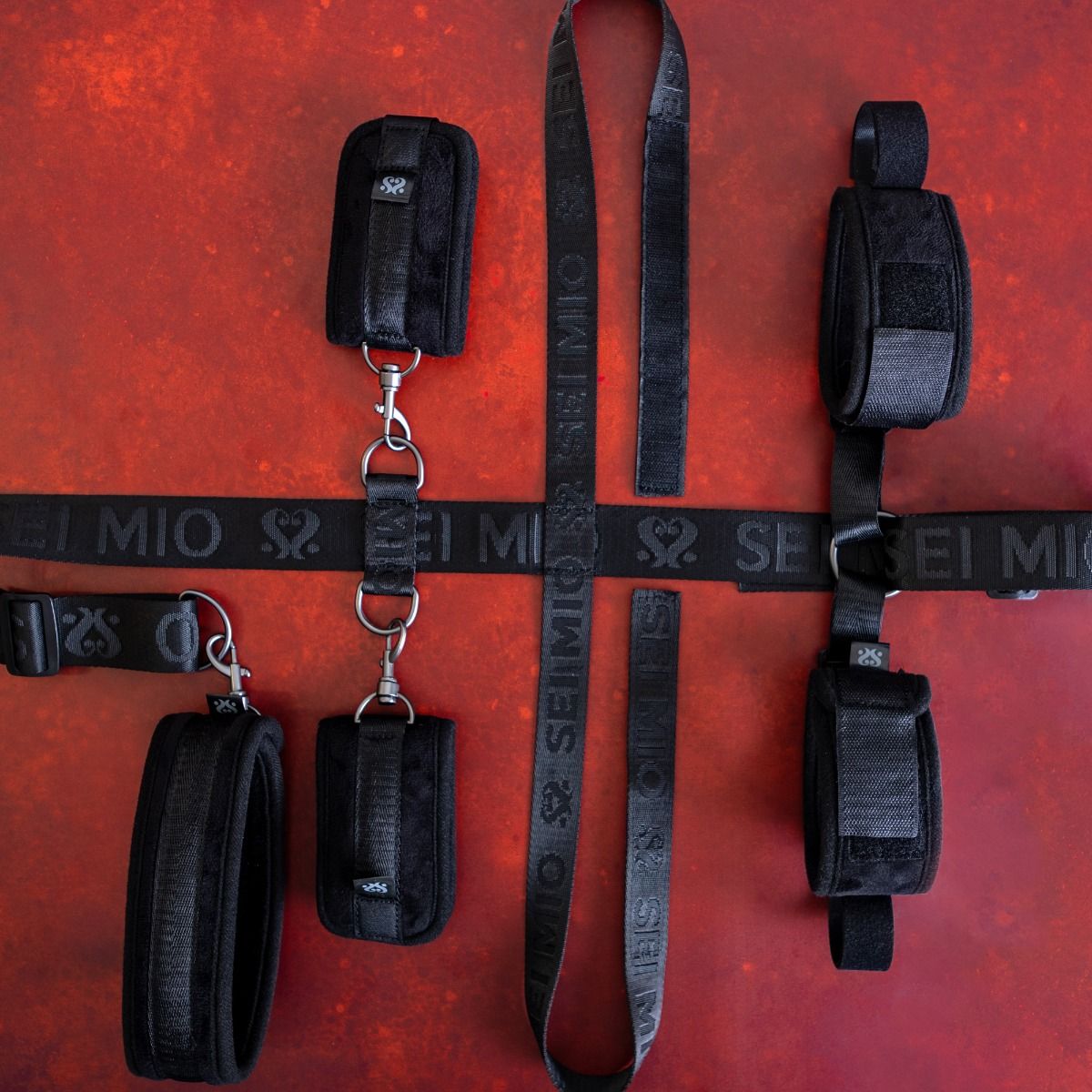 Black under chair restraint system with adjustable straps.