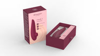 Womanizer Classic 2 clitoral stimulator in bordeaux, shown in its open box with accessories.
