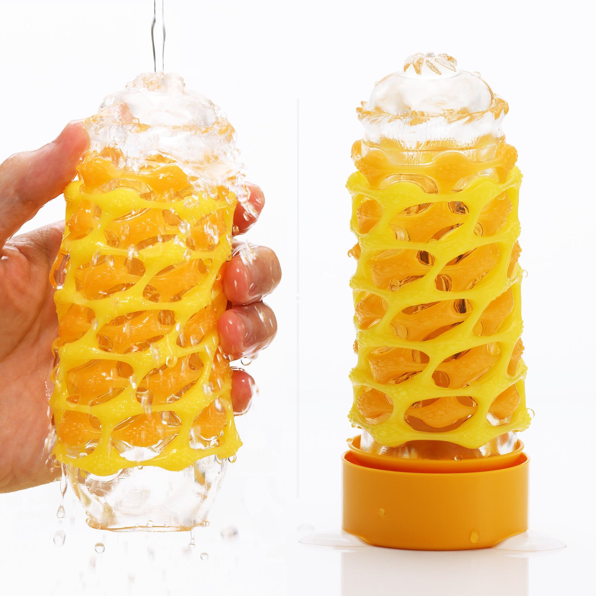 A yellow woven elastomer stroker filled with orange spheres, with water pouring over it.