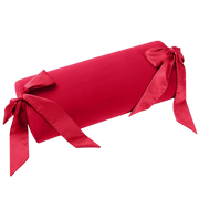 Red bolster pillow with silk sashes.