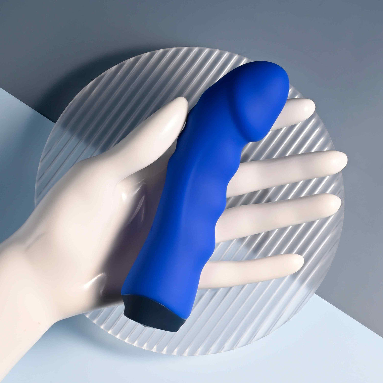 Blue silicone vibrator with a curved head and textured shaft.