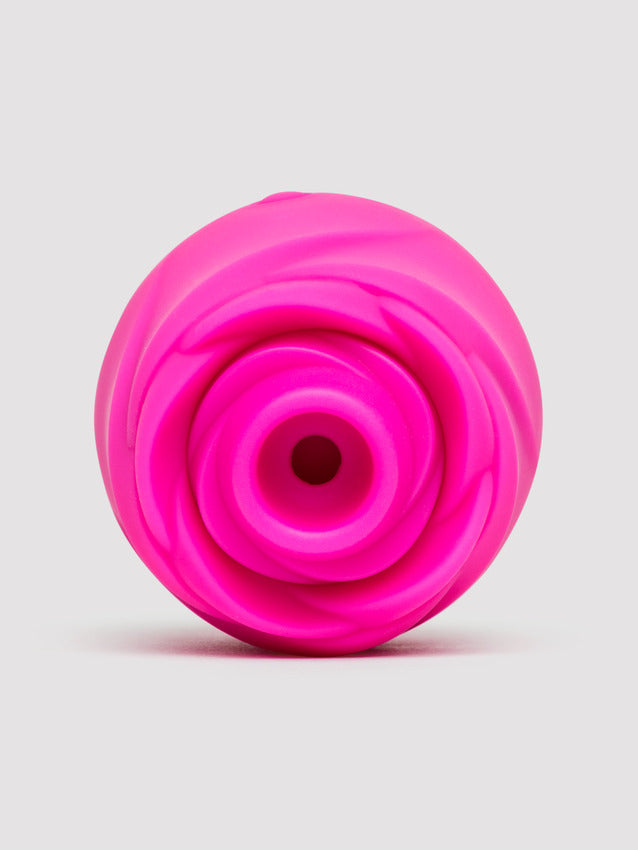 A bright pink silicone clitoral stimulator with a rose-like textured opening.