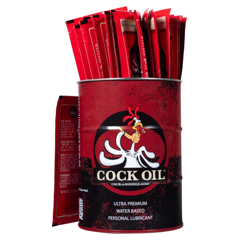 A red drum filled with foil packets of "Cock Oil" water-based lubricant.