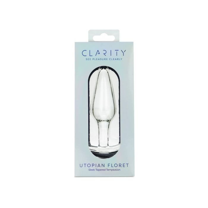 A clear glass anal plug with a tapered, floret-like shape in its packaging.