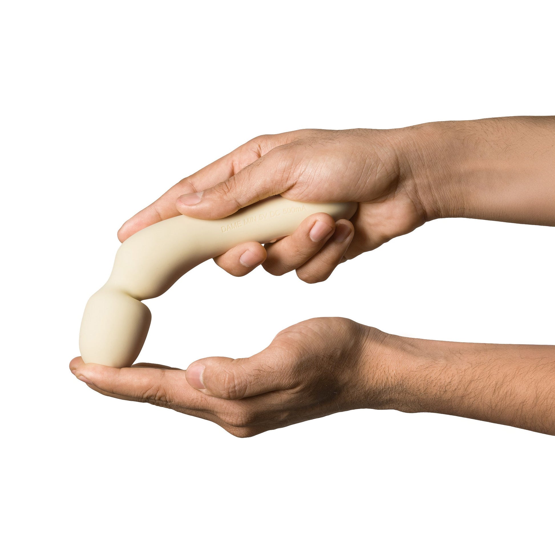 A beige, curved vibrator held by two hands.