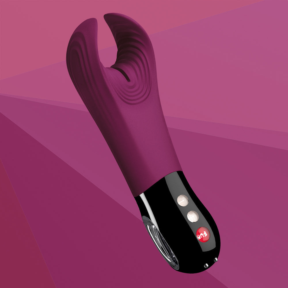 A garnet-colored textured stroker and vibrator with a black base and buttons.