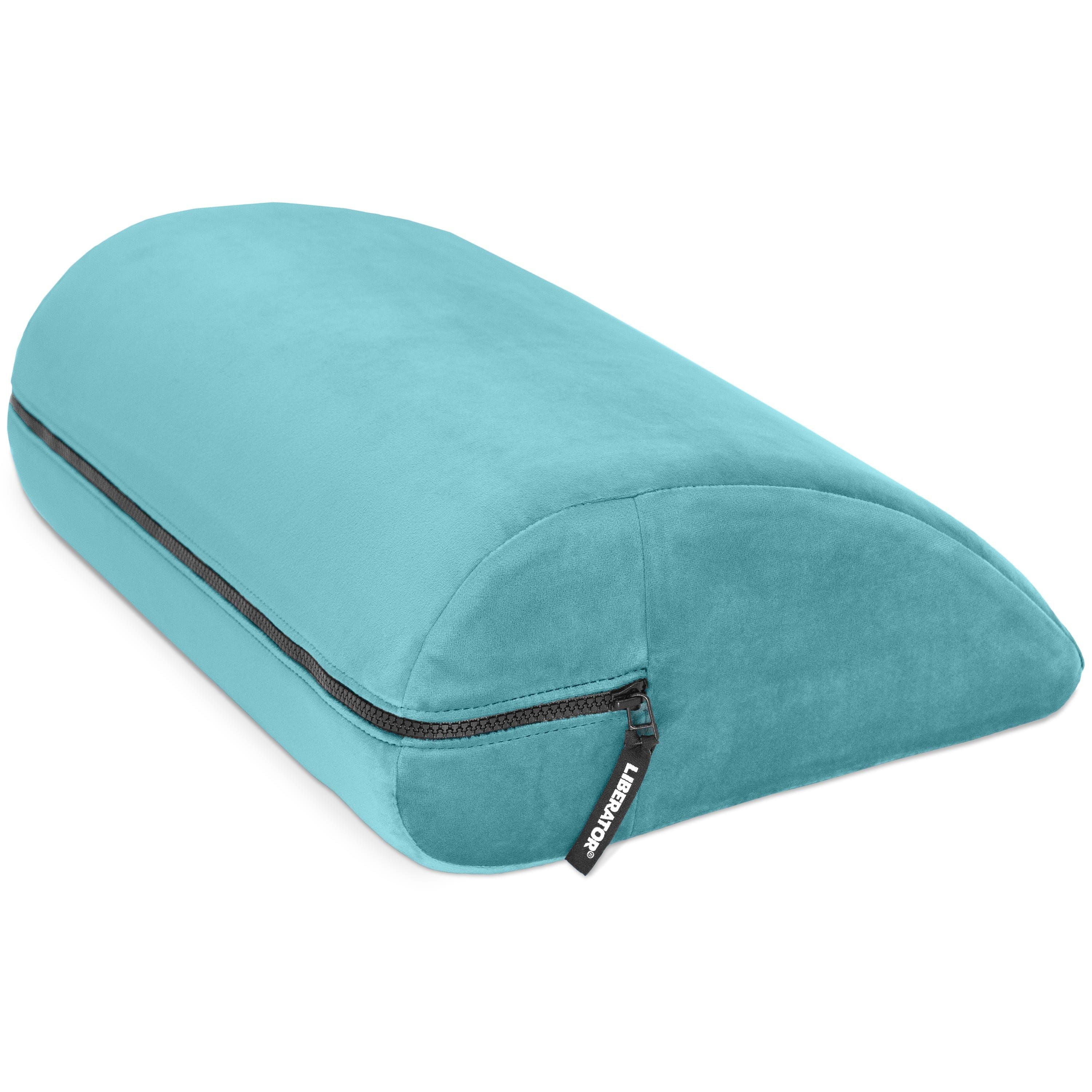 A teal microvelvet wedge pillow with a zipper and a black tag that says "LIBERATOR".