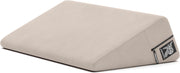 A cream-colored wedge positioning pillow with a zipper and logo.