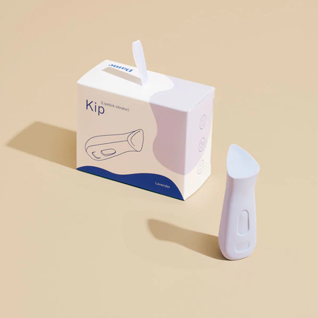 Lavender Kip clitoral vibrator next to its box.