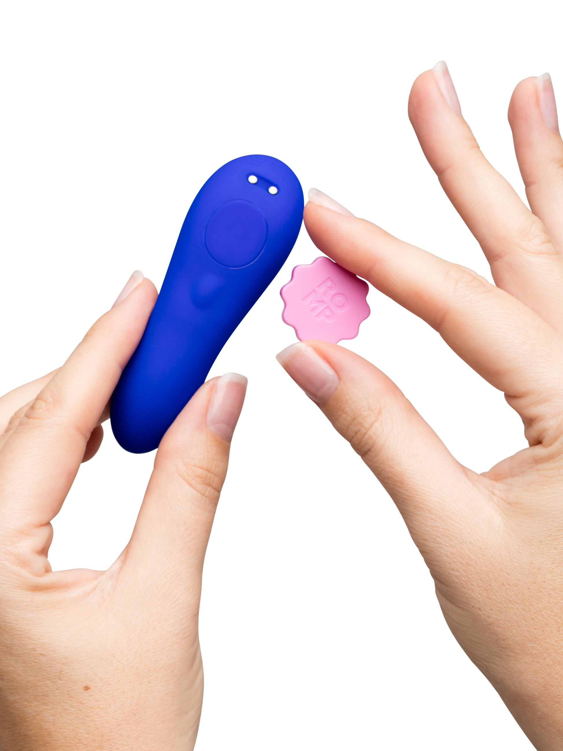 A blue remote control panty vibrator and a pink star-shaped accessory with "ROMP" on it.