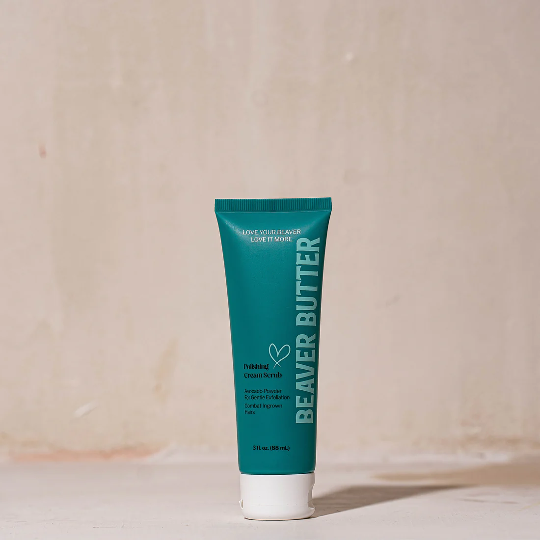 A teal tube of Beaver Butter Polishing Cream Scrub with white cap.
