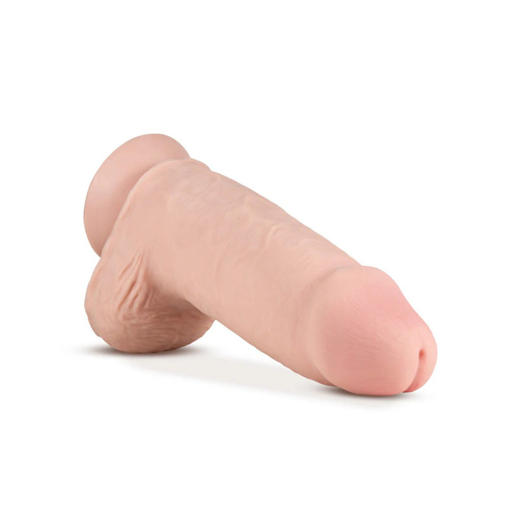 A 10-inch dual density dildo with thick shaft, realistic flesh tone, and suction cup base.