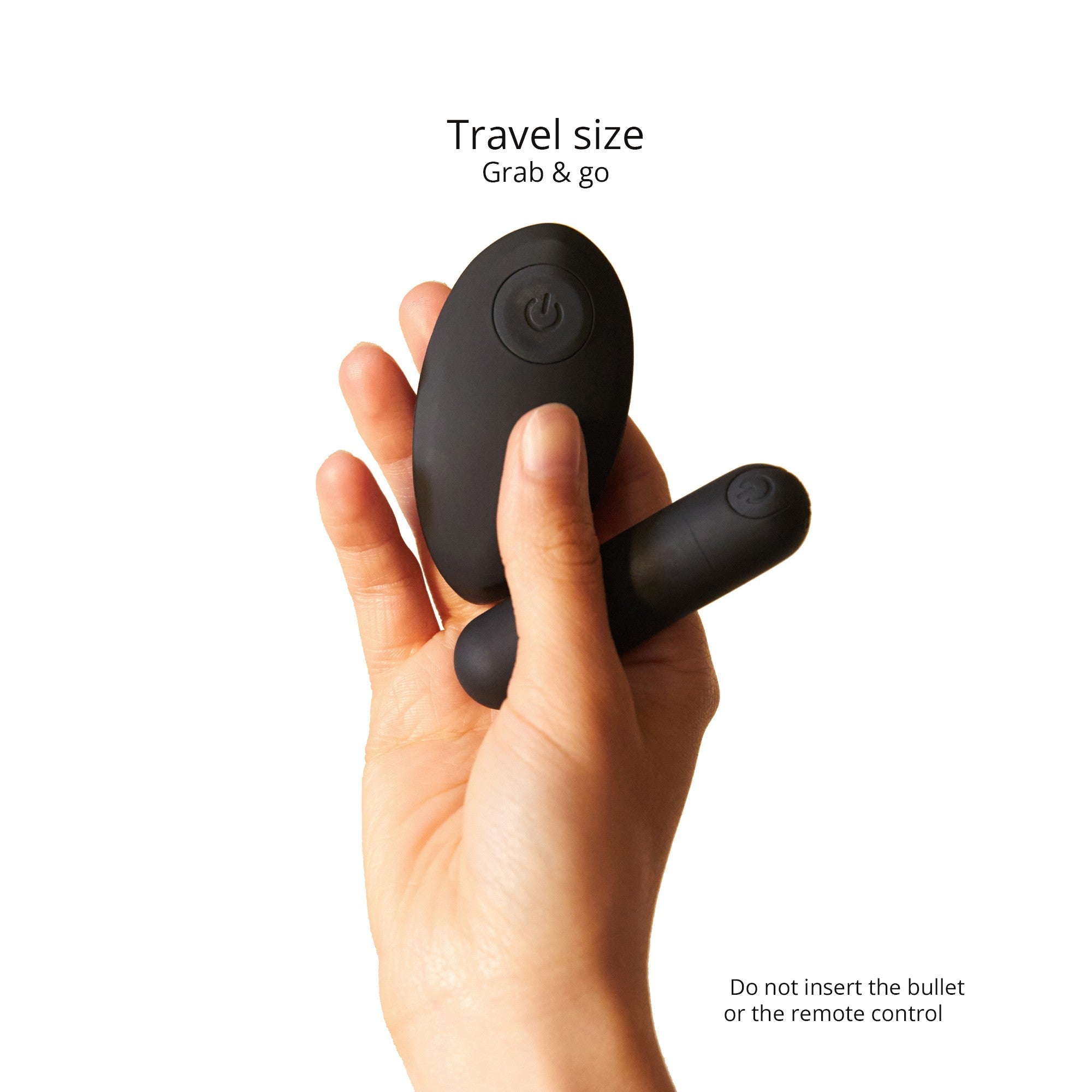 Black remote control and bullet vibrator held in a hand.