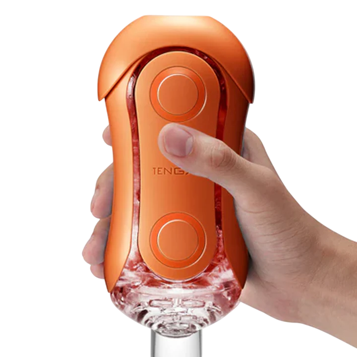 Tenga Flip Orb Sunset Orange reusable male stroker held in a hand.