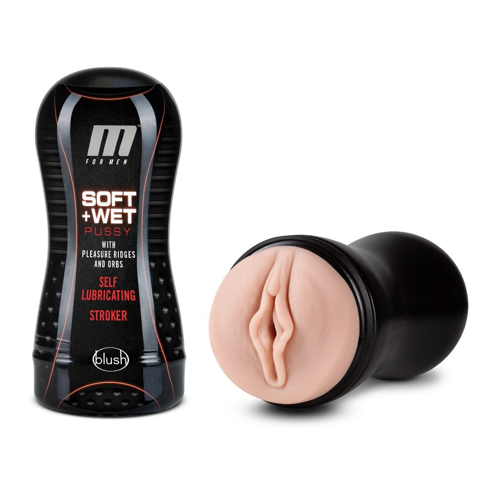 A black bottle of "Soft + Wet Pussy" lubricant next to a black and flesh-toned male stroker.