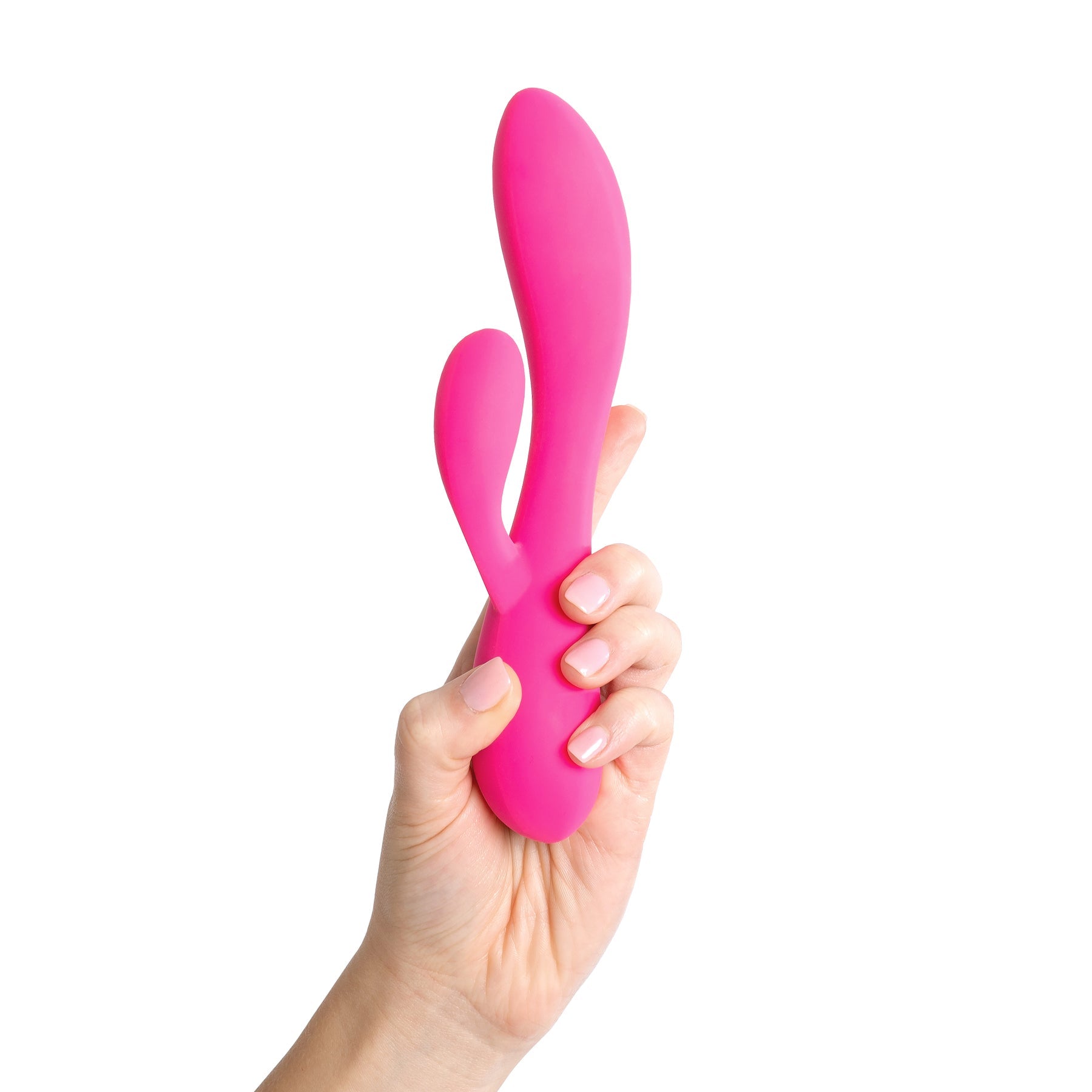 A pink dual motor rabbit vibrator held in a hand.