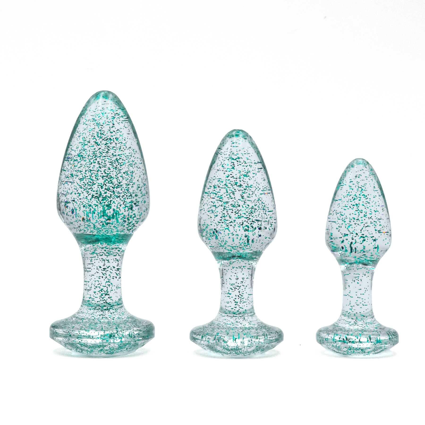 Three blue glitter anal plugs of varying sizes on a white background.