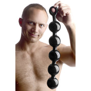 Black anal beads with a pull ring, made of TPE.