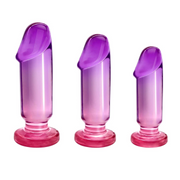 Three graduated purple and pink anal plugs with flared bases.