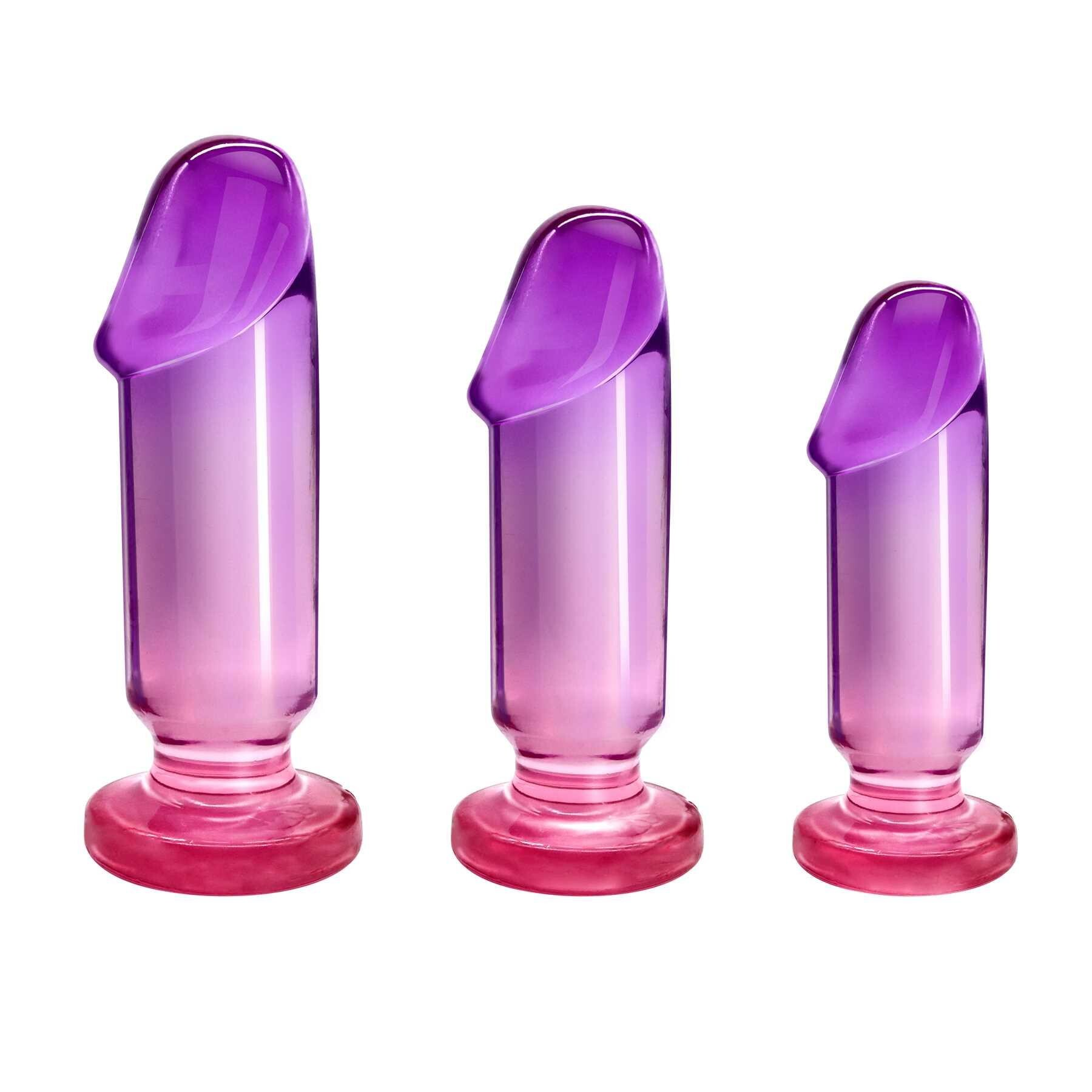 Three graduated purple and pink anal plugs with flared bases.