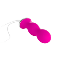 Pink pelvic floor trainer with a white string.