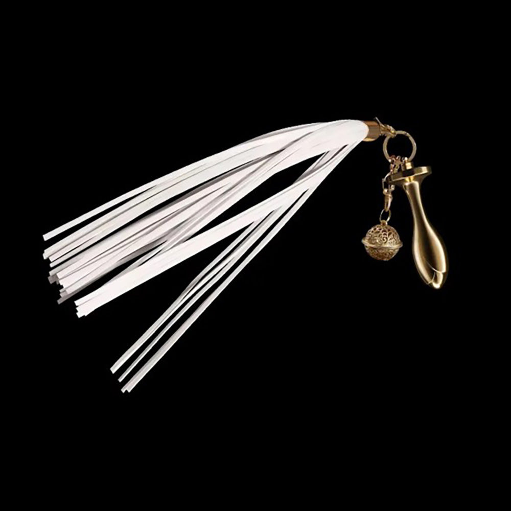 White leather flogger tail with a gold-toned anal plug and decorative ball.