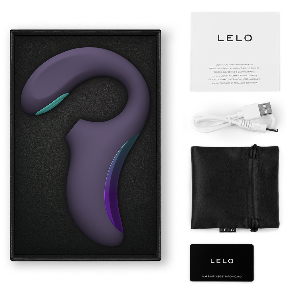A purple Lelo Enigma Double Sonic Massager with charging cable, manual, and storage pouch.