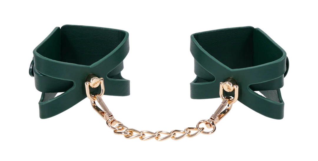 Emerald green cuffs with gold chain and hardware.