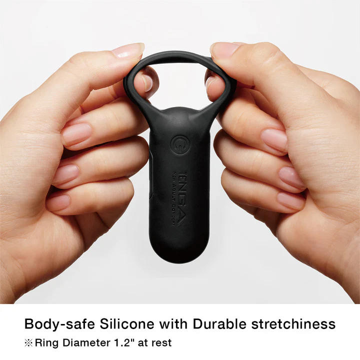 Black Tenga vibrating cock ring held by two hands, made of body-safe silicone.