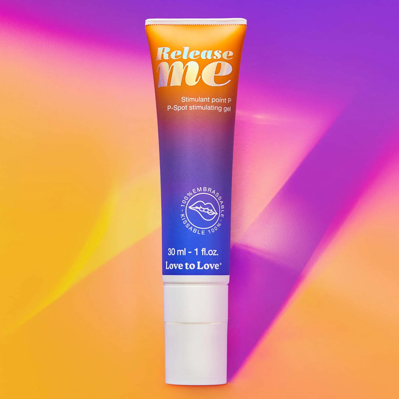 A tube of Release Me P-Spot stimulating gel with a gradient of orange to purple.