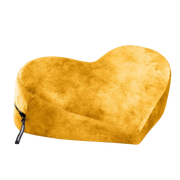 A yellow heart-shaped positioning pillow with a zipper and a tag.